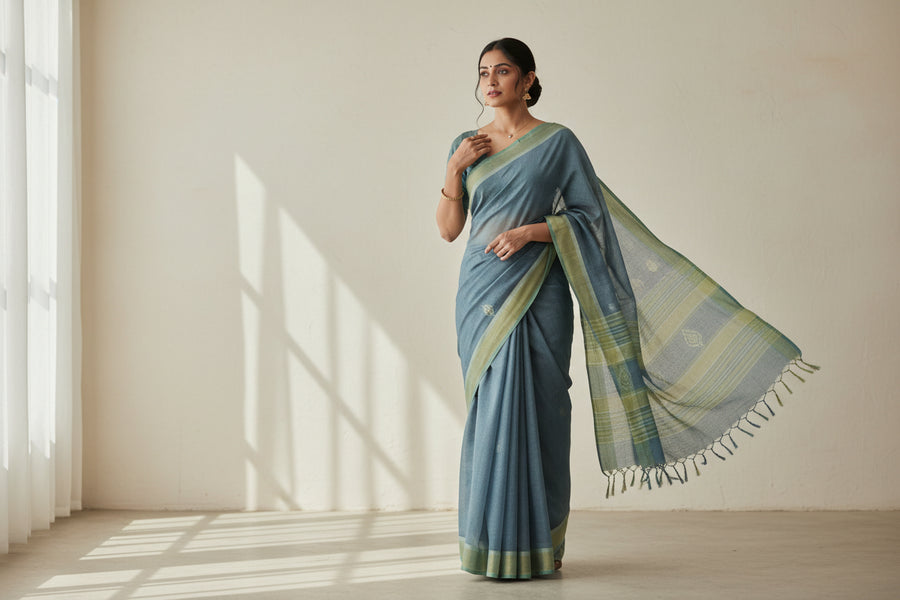 Create a professional ecommerce promotional image for a women’s South Indian everyday ethnic wear collection.
Theme & Style:
- Simple, elegant, and wearable
- South Indian traditional aesthetics with a modern touch
- Everyday comfort, not festive or luxury
- Premium but understated boutique feel
Subject:
- A South Indian woman wearing an everyday saree or ethnic outfit
- Cotton or cotton-silk saree preferred
- Soft, subtle colors (pastels, earthy tones, muted blues, off-white, light greens)
- Natural drap